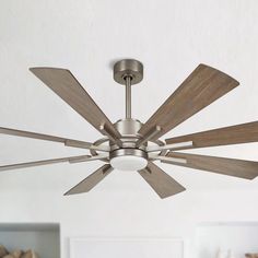 a ceiling fan with four wooden blades in a living room or dining room, showing the light fixture