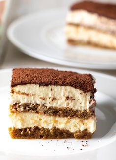 a piece of cake sitting on top of a white plate next to another slice of cake