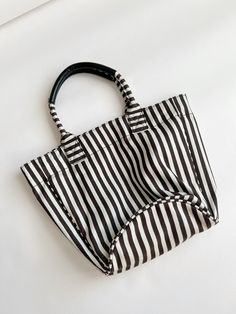 Super cute stripe tote bag, great for everyday errands or to go thrifting . MEASUREMENTS: Laying flat Length top to bottom w handles: 20 inches Horizontal length : 18 inches Bottom diameter : 10.5 inches Any questions regarding this listing, please dont hesitate to contact via DM. Please note these items are vintage/ second hand, they will have some signs of wear. If any major damage, it will be mentioned on the listing description. No returns or exchanges allowed Follow Sue's Market on Instagram @sues.mkt for daily updates, sneak peeks on new finds, and daily style inspo. Striped Travel Tote Shoulder Bag, Striped Tote Shoulder Bag For Travel, Everyday Tote Shoulder Bag With Striped Lining, Striped Double Handle Shoulder Bag For Travel, Striped Tote Beach Bag For Everyday, Striped Rectangular Beach Bag For Everyday Use, Everyday Striped Tote Beach Bag, Chic Daily Use Bags With Striped Lining, Everyday Bags With Striped Lining And Double Handle