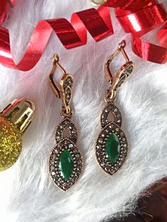 Authentic Turkish Style Unique Earrings Vintage Ottoman Style HURREM SULTAN   Hurrem Sultan Magnificent Century A beautiful and stylish accessory! Authentic and unique Turkish design. Ottoman-style vintage jewelry that will make you feel like real Sultana from Ottoman Dynasty. Named after The Great Hurrem Sultan, the earrings are antique gold in color with crystals and green resin stone. Elegant Green Earrings For Christmas, Elegant Silver Earrings For Christmas, Elegant Christmas Jewelry For Formal Occasions, Elegant Handmade Crystal Earrings For Festive Occasions, Elegant Christmas Formal Jewelry, Handmade Elegant Crystal Earrings For Festive Occasions, Elegant Christmas Drop Earrings, Elegant Green Hoop Earrings As Gift, Elegant Christmas Jewelry With Matching Earrings