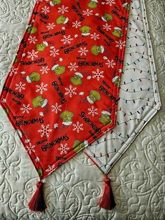 two red and white bandanas on top of a quilted tablecloth with christmas decorations