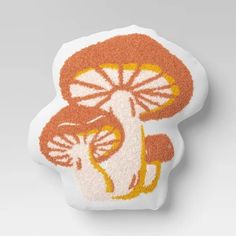 an orange and white mushroom shaped cushion