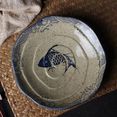 a blue and white plate sitting on top of a table next to utensils