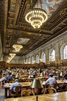 people are sitting at tables in the library