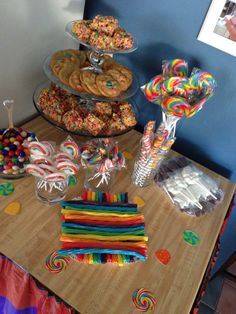 a table topped with lots of candy and lollipops