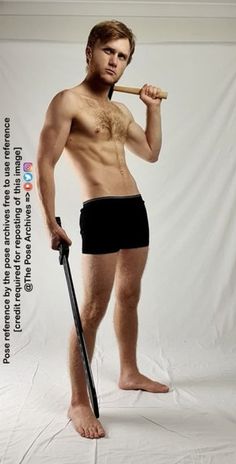 a man with no shirt is holding a baseball bat and posing for a photo in front of a white backdrop