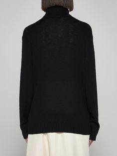 100% wool Elegant Black Fine Knit V-neck Sweater, Elegant Black V-neck Sweater For Work, Luxury Wool Sweater For Work, Luxury Merino Wool Sweater For Work, Luxury Merino Wool Workwear Sweater, Luxury Wool Sweater For Layering, Luxury Black Sweater For Formal Occasions, Luxury Fine Knit Formal Sweater, Luxury Merino Wool Sweater For Formal Occasions