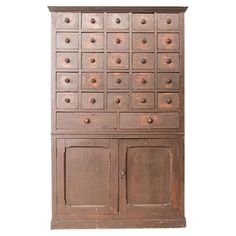 an old wooden cabinet with many drawers