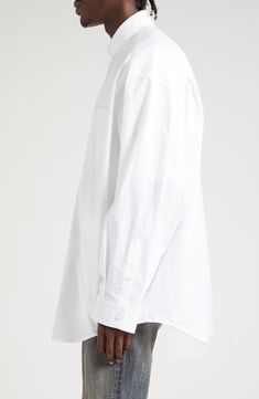 Balenciaga branding spans shoulder to shoulder beneath the back yoke of this button-down shirt cut in an oversized silhouette that befits the logo's length. 31" front length; 33" back length (size 2) Front button closure Button-down collar Long sleeves with button cuffs Chest patch pocket Curved hem 100% cotton Machine wash, line dry Imported Designer Clothing Classic Oversized Shirt For Daywear, Classic White Oversized Shirt, Classic Oversized White Shirt, Unstructured White Shirt For Daywear, Classic Oversized Tops With Button Closure, Balenciaga Branding, Oversized Silhouette, Cut Shirts, Button Down Collar