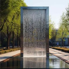 a large water fountain in the middle of a park