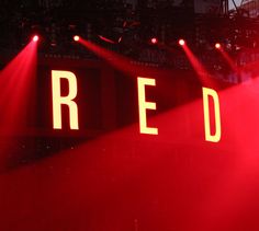 some red lights are shining on the stage