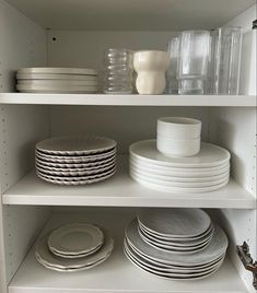 the shelves are filled with dishes and plates