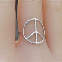 This is a handmade peace symbol ring, Express your inner hippie with this handcrafted peace symbol ring! Also available in 14k gold filled. Carefully and lovingly made in 925 sterling silver, hammered and textured for extra shine. Made to order! Size and dimensions: Available in any size 1-16 US including halves. Peace symbol is about 17mm Band thickness is 16guage or 1.2mm Shipping label upgrade: First class shipping 2-6 days Priority Mail shipping 1-4 days https://www.etsy.com/listing/12413334 Adjustable Sterling Silver Peace Sign Jewelry, Symbolic Silver Jewelry With Peace Sign, Rings Hippie, Peace Sign Ring, Jewelry Safe, Rings Silver, Shipping Label, Peace Sign, Ring Sterling Silver