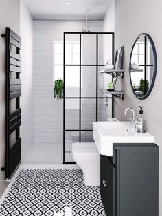 a bathroom with black and white tiles on the floor