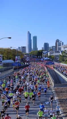 a large group of people running down a street