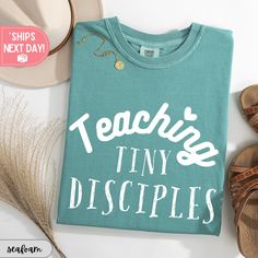 a t - shirt that says teach tiny disciples next to some shoes and a straw hat