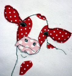 a cow with polka dots on it's head is shown in red and white