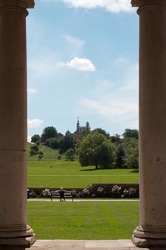 two columns in front of a grassy field