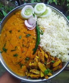 a bowl filled with rice, beans and veggies next to some sliced onions