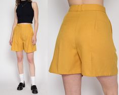 "Vintage 80s high waisted mustard yellow shorts with statement pleating at the front.  Measurements and Condition: Fits like: Women's medium Fabric: Feels like poly/rayon Brand: None Condition: Very good, the pleats have begun to fall out at the bottom of the legs but can be easily pressed back into place. Waist: 28\" Hips: 39\" - taken at the bottom of the zipper opening Rise: 14\" Inseam: 5\" Shown on a 5'8\" model with measurements of 34\"-26\"-37\", usually wears a size small. See our FAQ fo Yellow Workwear Bottoms Shorts, Yellow Short Bottoms For Work, Yellow Summer Shorts For Work, Yellow Short Length Bottoms For Workwear, Yellow Short Length Workwear Bottoms, Vintage Solid Bottoms For Summer, Vintage High Waist Shorts For Workwear, Vintage High-waist Shorts For Work, High Waist Vintage Shorts For Workwear