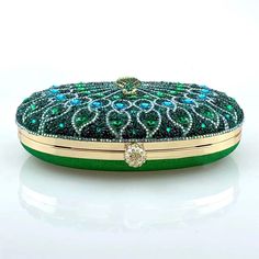 With its spectacular and detailed peacock design embellished with glittering rhinestones, this clutch provides an amazing pop of color that is sure to enthrall and dazzle. It's as practical as it is gorgeous, fitting all your necessities with ease. Embrace the extraordinary with the stunning Madyson Rhinestones Clutch Bag, combining precise craftsmanship and striking elegance. Now available in blue and green. Elegant Multicolor Clutch With Rhinestones, Green Rhinestone Party Evening Bag, Green Luxury Embellished Clutch, Luxury Green Embellished Clutch, Glamorous Green Evening Bag, Green Rhinestone Clutch Evening Bag, Elegant Green Evening Bag With Rhinestones, Formal Green Embellished Clutch, Embellished Green Clutch