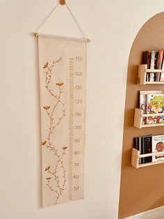 a ruler hanging on the wall next to some books