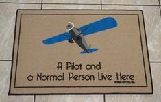 a door mat with an airplane on it that says, a pilot and a normal person live there