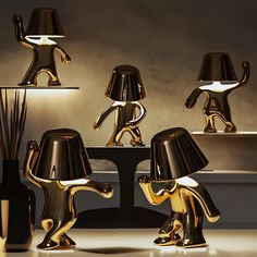 three black and gold lamps sitting on top of a table