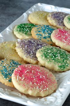 colorful cookies with sprinkles on a white plate