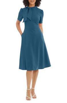 This dainty short sleeve dress is a retro inspired staple that's perfect for any well-dressed occasion. 45" length Necktie Short sleeves Back zip closure Lined 96% polyester, 4% spandex Hand wash, dry flat Imported Model stats: 5'10" height, 32" bust, 25" waist, 36" hip. Model is wearing size 2. Spring Dresses With Bow And Short Sleeves, Summer Work Dresses With Bow Detail, Retro Short Sleeve Midi Dress For Party, Summer Workwear Dresses With Bow, Summer Workwear Dresses With Bow Detail, Casual Short Sleeve Dress With Bow, Casual Midi Dress With Short Sleeves For Semi-formal Occasions, Fitted Midi Dress With Bow For Garden Party, Formal Short Sleeve Summer Dress