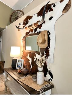 Cowhide Rug On Wall With Pictures, Cowhide Wall Decor Living Room, How To Hang A Cowhide On The Wall, Dollar Tree Western Decor, Cow Hide Rug On Wall, Cow Rug On Wall, Western Dresser Decor, Cow Hide Wall Decor Ideas, Cowhide On Wall