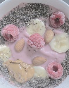 a bowl filled with fruit and nuts on top of a table