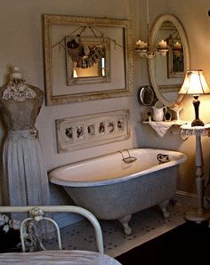 a white bath tub sitting under a bathroom mirror