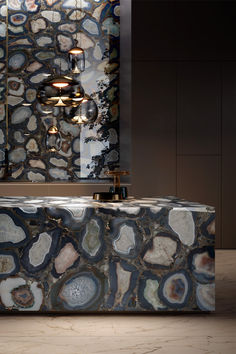 a bath tub sitting in front of a mirror next to a wall with lights on it