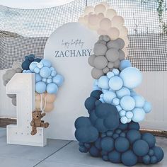 there is a large balloon sculpture in front of a fenced area with a teddy bear next to it