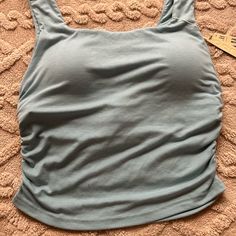 Square Neck Tank Top. Never Used With Etiquette. Light Blue Summer Tank Top With Built-in Bra, Light Blue Stretch Sleeveless Crop Top, Blue Seamless Sleeveless Crop Top, Blue Sleeveless Seamless Crop Top, Sleeveless Seamless Blue Crop Top, Seamless Sleeveless Blue Top, Light Blue Seamless Sleeveless Crop Top, Blue Sleeveless Crop Top For Yoga, Light Blue Seamless Tank Top For Spring