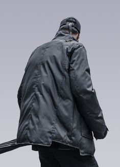 Get ready for any challenge with the ultimate Techwear Winter Jacket. Discover the Techwear Padded Jacket - a winter essential that boasts style and functionality, perfect for urban dwellers looking to make a statement. This winter techwear jacket is more than just a coat, it's a technological marvel. Picture yourself walking down the street, turning heads in this sleek, charismatic jacket. This futuristic jacket is perfect for anyone looking to make a statement and stay warm during winter. Crafted with meticulous attention to detail, this jacket is designed to keep you warm and dry against the harshest winter conditions. The sleek, mid-length silhouette exudes an avant-garde vibe that will not leave people indifferent. At the same time, the buttons and straps on the shoulders add a tactic Functional Windproof Sport Coat For Winter, Functional Windproof Sport Coat For Fall, Functional Windproof Winter Sport Coat, Fall Windproof Functional Sport Coat, Urban Nylon Winter Outerwear, Urban Nylon Outerwear For Winter, Techwear Utility Jacket With Functional Pockets For Outdoor, Urban Utility Jacket With Multiple Pockets, Urban Nylon Parka For Cold Weather