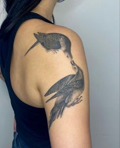 a woman with two birds on her shoulder and one is holding the other's arm