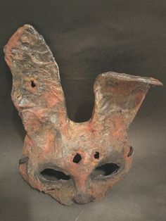 Dark rustic rabbit mask with a flopped ear and a few holes here and there. A weathered rustic old feel to it. One size fits all with the adjustable elastic strap.  One of a kind Original rustic and weathered animal masks I make from scratch. This is the rabbit mask. These are my new line of animal masks in my shop and I can do this distressed appearance to any other animal mask mold I have made in my store. Please contact me first for a quote. A very unique design I created featuring a thick paper mache mold with a rough sand paper textured material on top. Weathered rustic colors are infused and rubbed into the mask for a great authentic distressed feel. Acrylic paints are added into this lovely color palette. All masks come with little weathered holes in them (See images for this rabbit) Novelty Eye Mask For Halloween, Novelty Halloween Eye Mask, Cardboard Mask, Rustic Paper, Rabbit Costume, Paper Mache Mask, Mask Masquerade, Rustic Colors, Costume Mask