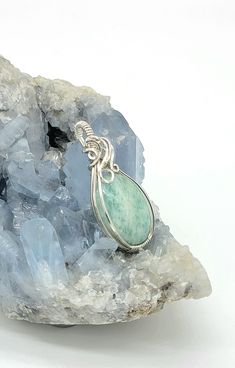 Nice amazonite cabochon-- see all pics especially close ups. Stone has a few areas of rough finish that flash with chatoyancy! Video found on my instagram @leetwraps This is made from .925 sterling silver. Ready to wear! Comes on an 18 inch stainless steel chain as seen in the photos... also comes in a gift box and with a polishing cloth. Artisan Amazonite Jewelry For Healing, Handmade Silver Larimar Jewelry, Handmade Silver Jewelry With Larimar, Artisan Amazonite Gemstone Jewelry, Unique Silver Amazonite Jewelry, Handmade Silver Aventurine Jewelry, Handmade Unique Larimar Jewelry, Silver Amazonite Jewelry With Natural Stones, Silver Amazonite Gemstone Jewelry