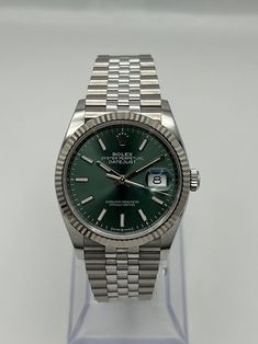 Released in 1945, the Datejust is Rolex’s longest standing collection and was created to commemorate the company's 40th anniversary. Unlike other Rolex watches, the Datejust was not designed for a specific activity or environment and simply exists as a smart, reliable timepiece. Pioneering for its time, the Datejust was the first self-winding watch to feature a date display window and also the first Rolex watch to use the Jubilee bracelet design. Combined with the tried and true Oyster case, the Matte Green, Luxury Watch Brands, Rolex Watch, Bracelet Design, Patek Philippe Nautilus, Breitling Navitimer, Rolex Day Date, Audemars Piguet Royal Oak, Rolex Gmt