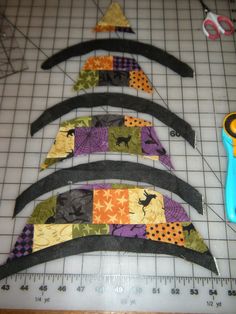 four pieces of fabric are laid out on a cutting board with scissors and rulers