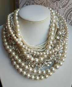 "Chunky pearl necklace, wedding statement necklace, trending necklace, rhinestone pearl necklace, wedding jewelry for bride, mother of bride This is a fabulous statement necklace, made with crystal pearls and crystals in abundance. It is the utmost glamour statement necklace, perfect for the boho bride or mother of bride. There are 6 layers of 6mm pearls, 1 layers of 8 and 2 layers of 12mm pearls, accentuated with crystal band that has teardrop and navette crystals adding a lot of shine and gla Luxury Glass Jewelry For Weddings, Glamorous White Bridal Necklace For Anniversary, Glamorous Crystal Pearl Necklace For Wedding, Elegant Pearl Necklace With Rhinestones For Wedding, Glamorous Pearl Embellished Necklace For Weddings, Glamorous White Pearl Necklace For Wedding, Pearl Necklace Outfit, Chunky Pearl Necklace, Necklace Outfit