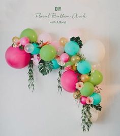 balloons and greenery are hanging on the wall in front of an instagramt for greenweddingshoes