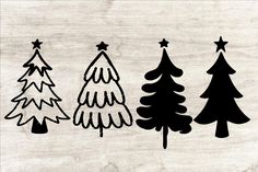 three christmas trees are shown in black and white on a wood background, with stars above them