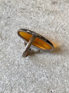 Circa 1920s Art Deco Dragons Breath Art Glass Sterling Silver Antique Ring Ring size 4, can be sized by a skilled jeweler Vintage Open Ring With Cabochon, Vintage Amber Engraved Jewelry, Vintage Hallmarked Round Opal Ring, Vintage Amber Jewelry With Engraved Details, Vintage Amber Jewelry With Polished Finish, Modernist Oval Cabochon Rings, Vintage Adjustable Rings With Polished Finish, Art Deco Engraved Oval Rings, Art Nouveau Engraved Ring Jewelry