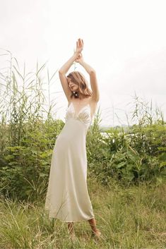 This maxi dress is made of satin and features a v neckline, thin, adjustable, crossed shoulder straps on the back, a side zipper closure, a flowy fit and a light, soft, shiny material. This maxi dress comes in ivory. Also available for made-to-order (MTO) in other colors and sizes. Please send us an inquiry. Long White Flowy Dress, Innocent Dress, Maxi Silk Dress, White Flowy Dress, White Silk Dress, White Dress Formal, Open Back Dress, Open Back Dresses, Silk Maxi Dress