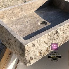 a stone sink sitting on top of a counter