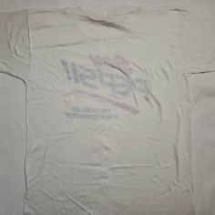 "Brand: Screen Stars Best Size: L Vintage t-shirt from 1989 Made in the USA Single stitch Measurements: Chest: 20\" Shoulder to shoulder: 18\" Back collar to hem: 26\" Spot on graphic near bottom of graphic and on left sleeve; see photos." 90s White Fan Merchandise T-shirt, 90s Crew Neck Fan Merchandise Top, White Grunge Fan Merchandise Top, White Grunge Fan Merchandise Tops, 90s Style Logo Print Fan Merchandise Tops, 90s Logo Print Tops For Fan Merchandise, 90s Logo Print Tops For Fans, 90s Style T-shirt With Text Print For Fans, 90s Style Logo Print Tops For Fans