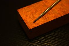 a pen sitting on top of a wooden box